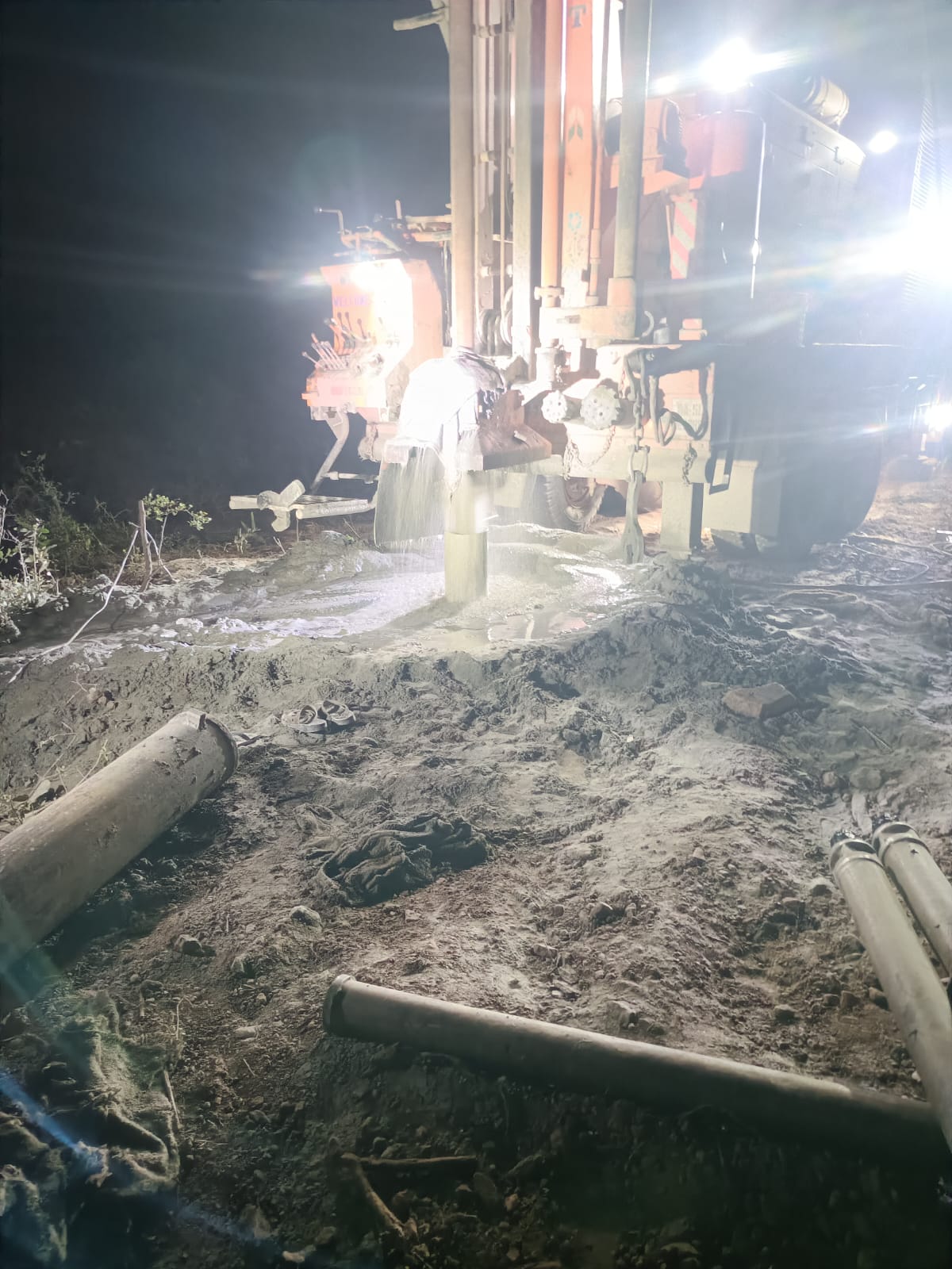 Night borewell drilling operation with water output